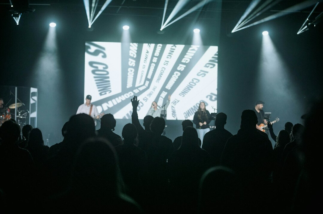 Large conference stage with an audience and screens